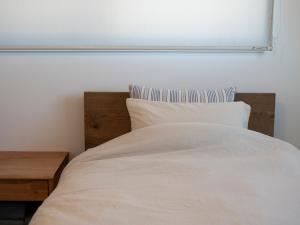 Postel nebo postele na pokoji v ubytování GLOCE長谷 QRPハウスKAMAKURA + 50 fotografií