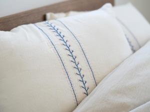 a baseball pillow sitting on top of a bed at GLOCE長谷 QRPハウスKAMAKURA in Kamakura
