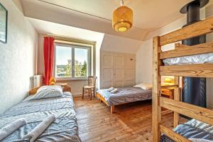 a bedroom with two bunk beds and a desk at Maison 15pers 300m de la plage in Crozon