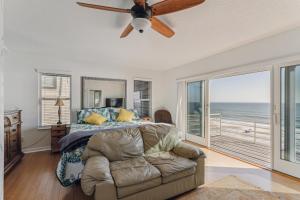 a bedroom with a bed and a ceiling fan at Breathtaking Beach Front House home in St. Augustine