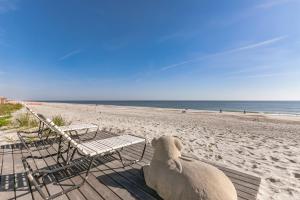 a sheep sitting on a bench at the beach at Breathtaking Beach Front House home in St. Augustine +22 photos
