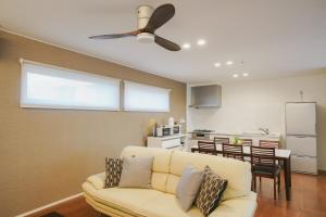 Il comprend un salon avec un canapé blanc et une cuisine. dans l'établissement Kunigami-gun - House / Vacation STAY 47389, à Onna