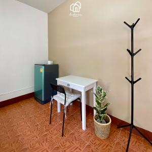 an office with a white desk and a chair at Andaman Residence in Thalang