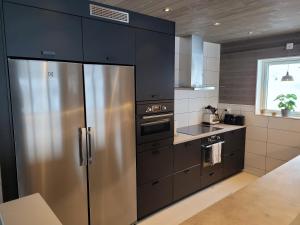 a kitchen with a stainless steel refrigerator and a stove at Tärnaby Ry Vy in Tärnaby