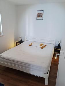 a white bed in a room with white sheets at Green oasis Deda Božo in Rovinj