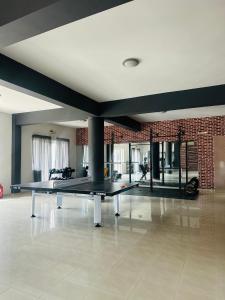 a ping pong table in the middle of a room at Nautica Hotel Apartments in Stavromenos