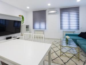 a living room with a blue couch and a table at 18 Beautiful Costa Rica Apartment Madrid in Madrid