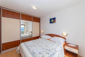 Postel nebo postele na pokoji v ubytování Apartments Palmero