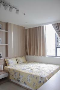 a bedroom with a large bed with a window at Ly Homestay - Nera Garden Huế in Hue