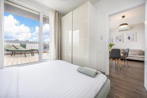 a bedroom with a bed and a large window at SMILGA & KOPA home - Mano jūra 2 Kunigiškiai - by Hello Sea homes in Palanga +75 photos