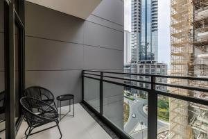 a balcony with a chair and a view of a city at Elegant Brand New Studio Wilton Park Residence MBR in Dubai