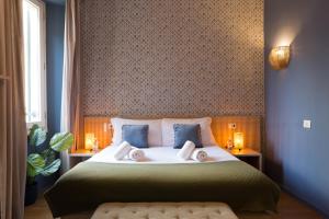 a bedroom with a bed with two pillows on it at The Convo Lake Como in Como