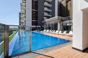 a swimming pool on the balcony of a building at Elegant Brand New Studio Wilton Park Residence MBR in Dubai