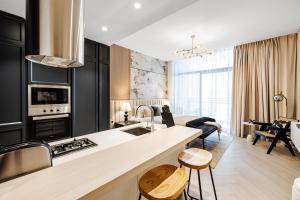 a kitchen and living room with a sink and a counter at Elegant Brand New Studio Wilton Park Residence MBR in Dubai