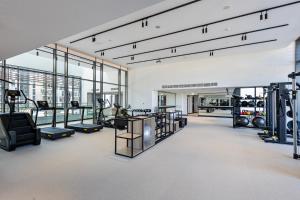 a gym with treadmills and equipment in a building at Elegant Brand New Studio Wilton Park Residence MBR in Dubai
