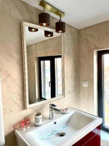 a bathroom with a sink and a mirror at Hotel City Break in Galaţi