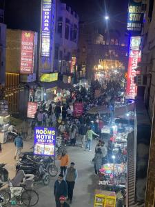 a group of people walking through a market at night at HOTEL D.S in Amritsar