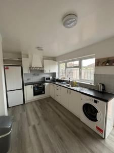 a large kitchen with a sink and a dishwasher at 30 min STN or to central London in Enfield Lock