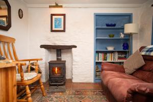 a living room with a couch and a wood stove at Maes yr Afon St Dogmaels in Saint Dogmaels