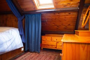 a bedroom with a bed and a window and a dresser at Maes yr Afon St Dogmaels in Saint Dogmaels