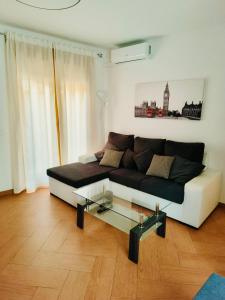 a living room with a couch and a glass table at APARTAMENTOS TURISTICOS MONTASOL in Montánchez