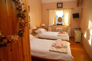 a room with two beds with a baby on them at Y Cartws Llanwenog in Llanwenog