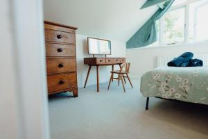 a bedroom with a dresser and a bed and a desk at Lower Bubbleton Penally in Penally