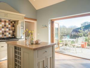 an open kitchen with a view of a patio at Lower Bubbleton Penally in Penally