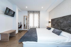 Postel nebo postele na pokoji v ubytování Hostal Boutique Aurora