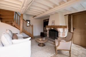 uma sala de estar com um sofá e uma lareira em Maison Longere Beautiful House near Deauville em Cricquebœuf