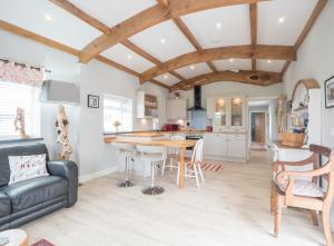 a kitchen and living room with a table and chairs at White Fields Cottage Carmarthen in Carmarthen