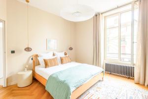 a bedroom with a bed and a large window at Villa Marie climatisation piscine & jardin Dijon centre in Dijon +27 photos