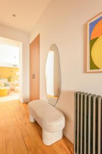 uma sala de estar com uma cadeira e um espelho em Villa Marie em Dijon