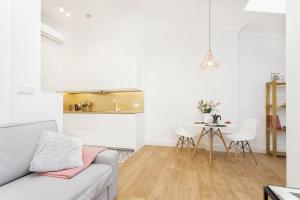 a living room with a couch and a table at Radziwiłłowska Old Town Apartments in Krakow