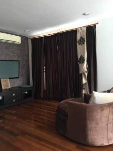 a living room with a couch and a flat screen tv at Duplex Condominium In Bukit Bintang For Rent in Kuala Lumpur