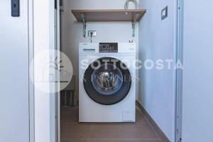 a washing machine in a room with a door at Infiore Apartment in Leverano