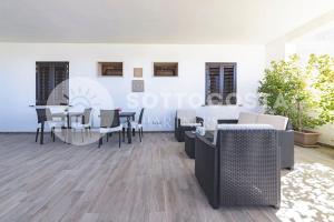 a dining room with tables and chairs in a building at Infiore Apartment in Leverano