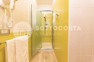 a shower with a glass door in a bathroom at Infiore Apartment in Leverano +44 photos