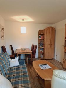 a living room with a couch and a table at Heidtschmidhof Gästehaus in Wolgast