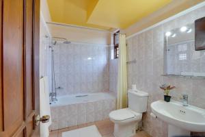 a bathroom with a toilet and a sink and a tub at AIDA Hotel - Bentota in Bentota