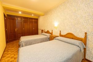 Cama o camas de una habitación en Escuder Apartamentos Turísticos