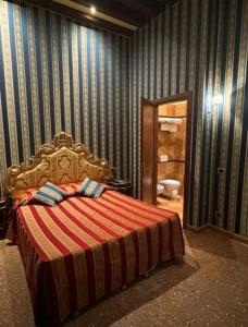 a bedroom with a bed and a bathroom with a toilet at Ca' San Zaccaria in Venice