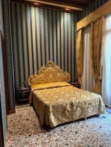 ein Schlafzimmer mit einem Bett in einem Zimmer mit gestreiften Wänden in der Unterkunft Ca' San Zaccaria in Venedig