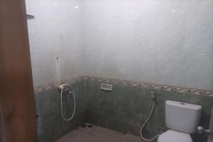 a bathroom with a toilet and a shower at Permata Hijau in Cirebon