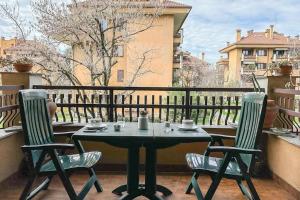 a table and two chairs on a balcony at [10 minuti dall'aeroporto] Linate Studio Flat in Peschiera Borromeo
