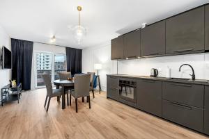 a kitchen with a table and a dining room at Lumina 2-room apartment with beautiful view Lodz in Łódź