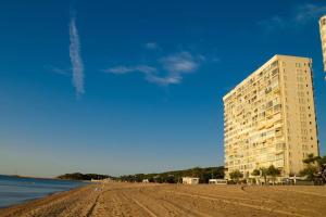 a building on a beach next to the water at Bambu Beach Studio by BHomesCostaBrava in Platja d'Aro