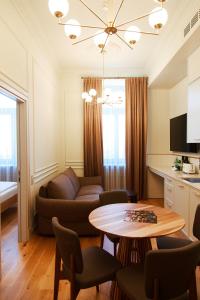 a living room with a couch and a table at Roze Center Apartments in Liepāja