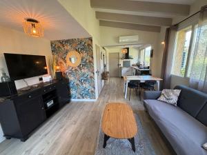a living room with a couch and a table at Gîte Cazoletta in Casalabriva