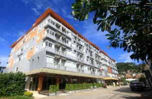 a large white building with a pointed roof at Breezotel - SHA Certified in Patong Beach